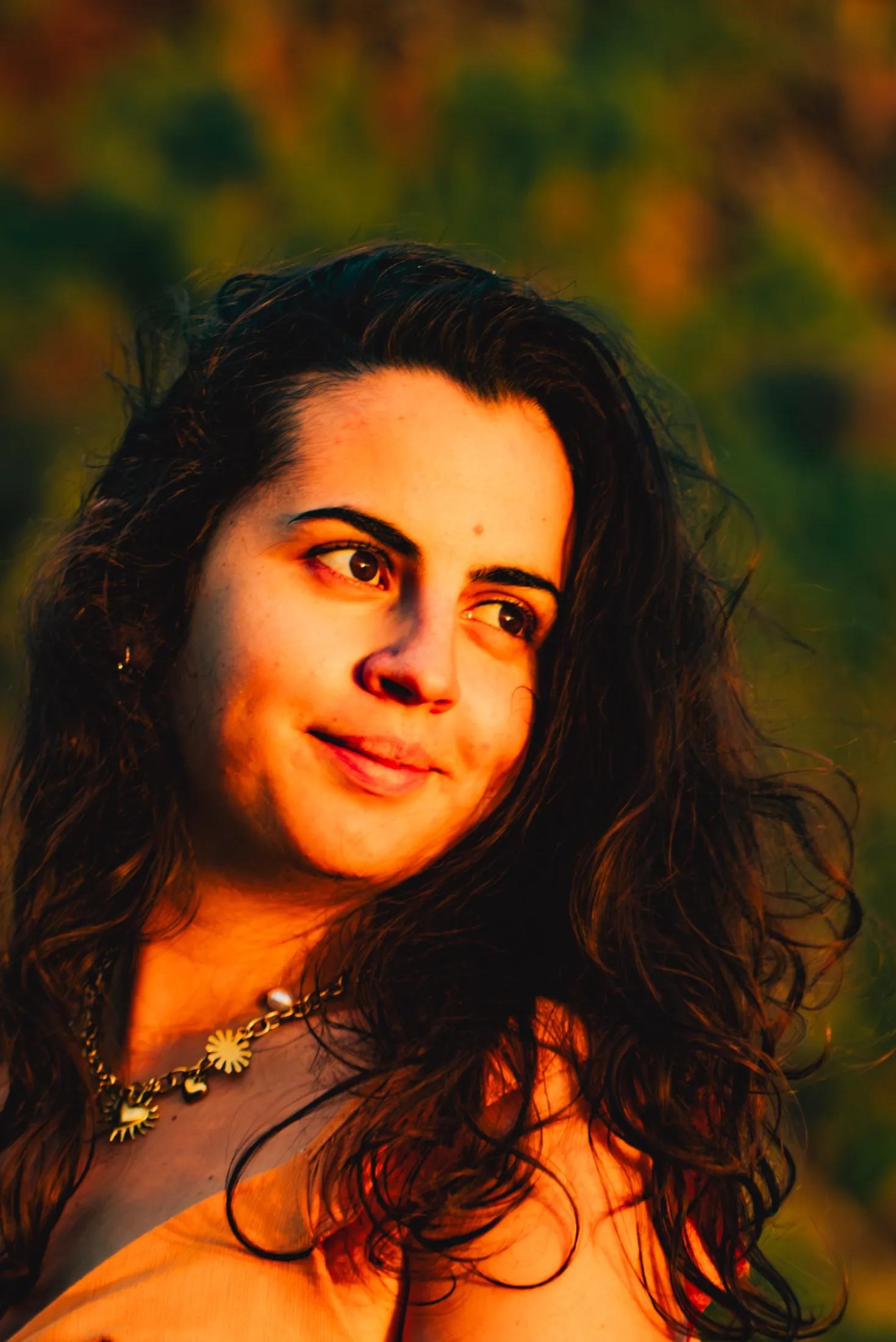 A young woman turns towards low evening light