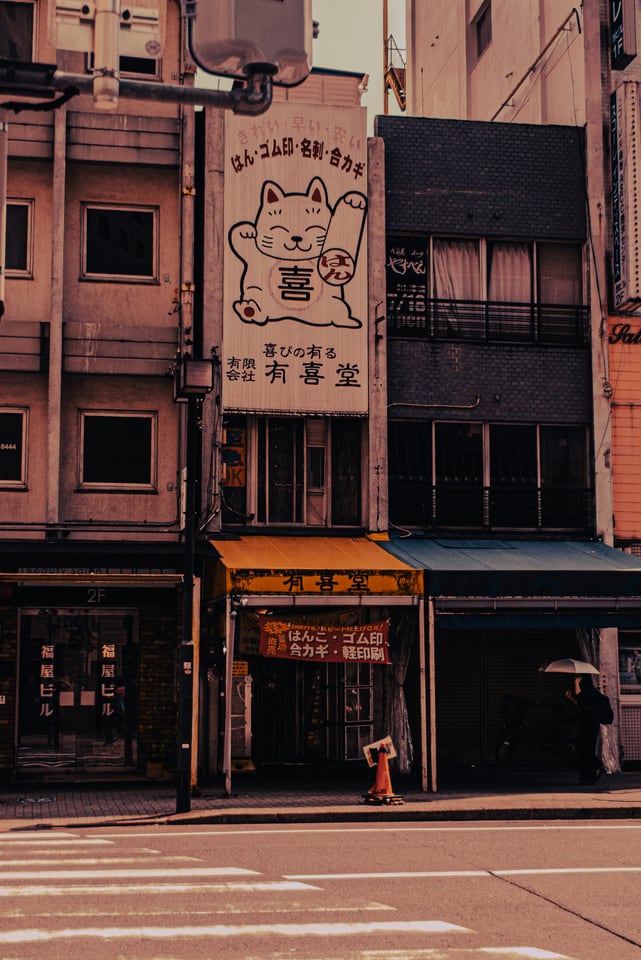 An empty street corner beneath a pale morning sky.
