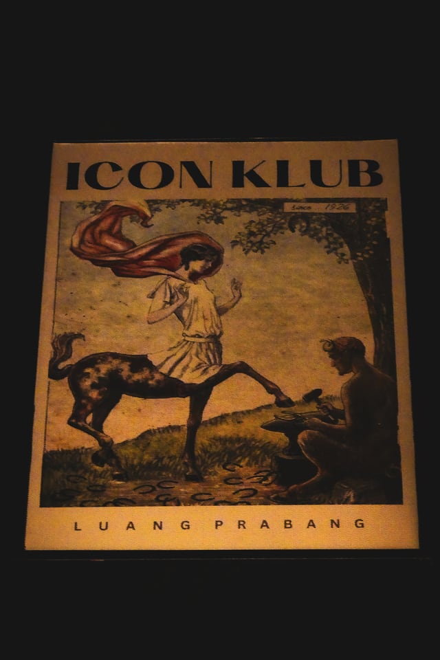 A painted Icon Klub sign shows a centaur figure and the words Luang Prabang against a dark wall.